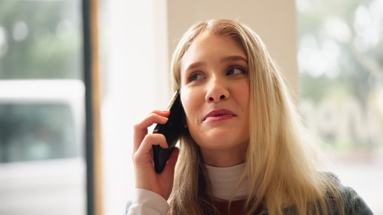 A woman with blonde hair is talking on the phone