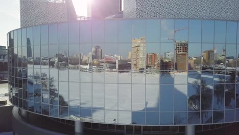 modern building reflecting cityscape in winter