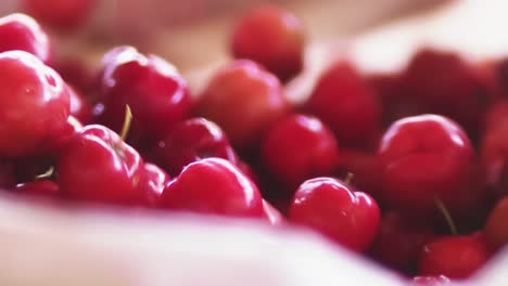 farm fresh acerola cherries drop into a basket