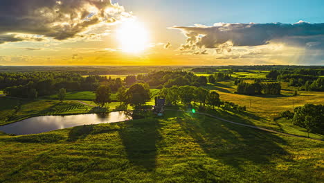 Colorful-sunset-cloudscape-over-rural-farmland-fields---forward-aerial-hyper-lapse