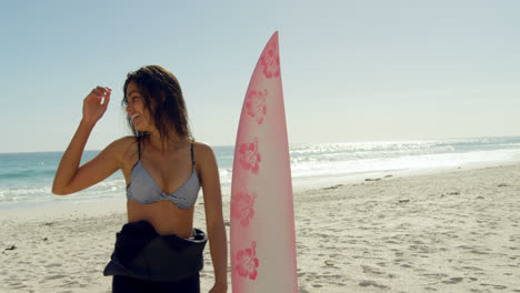 female surfer playing around the surfboard on beach 4k 4k