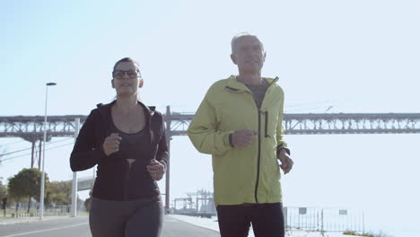 pareja feliz corriendo juntos en un día soleado