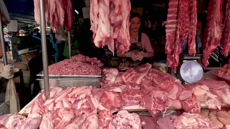 vendors selling fresh meat at a busy market