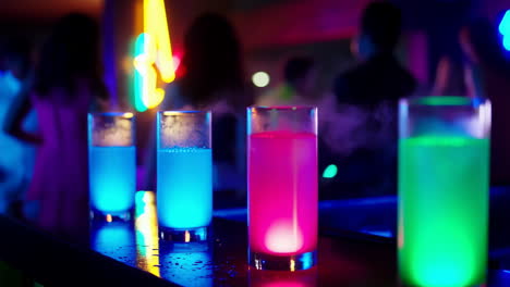 vibrant glowing drinks at a nightclub