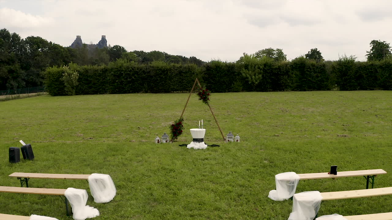 Simple decorated wedding altar and benches for an outdoor wedding