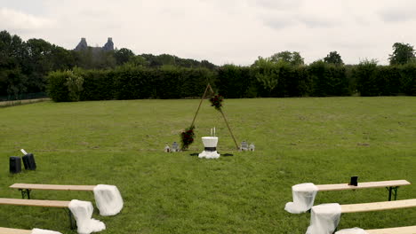 simple decorated wedding altar and benches for an outdoor wedding