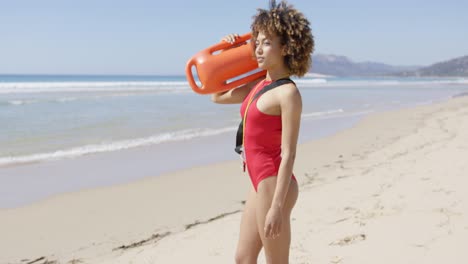 Female-lifeguard-looking-into-distance-on-beach