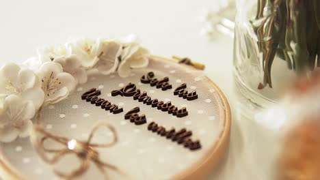 Toma-Panorámica-A-Cámara-Lenta-De-Un-Pastel-De-Bodas-Con-Una-Fuente-De-Chocolate,-Arco-Y-Rosas-Blancas-Decoradas-En-Una-Mesa-Blanca