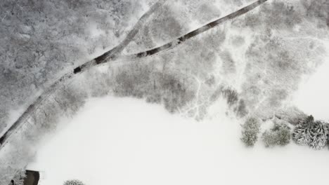 4-4aerial flyover winter snow covered trees and victoria park golf course with a backroad forks with freshly snow plowed for service vehicles to enter exit grounds area at the edge of the propertyline