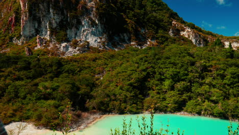 Turning-to-look-at-blue-Lake-at-Rainbow-mountain,-Rotorua,-New-Zealand