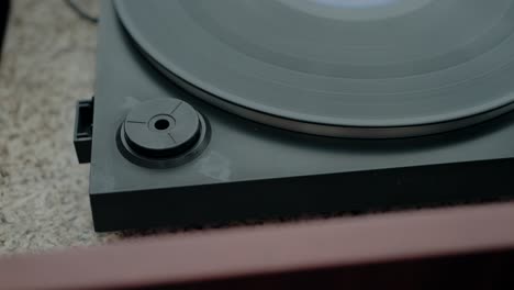 Close-up-of-a-vinyl-record-player,-highlighting-its-classic-design-and-nostalgic-appeal