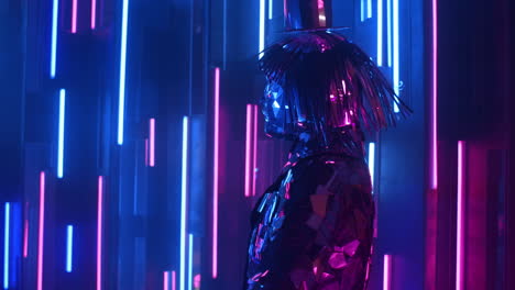 a steel silver woman dances in a glittering costume in the light of a neon wall.