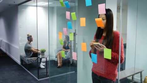 animation of glowing lights over asian businesswoman in office