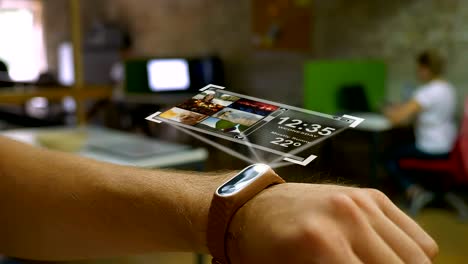 futuristic device on a man's hand, a hologram, smart watch office in the background