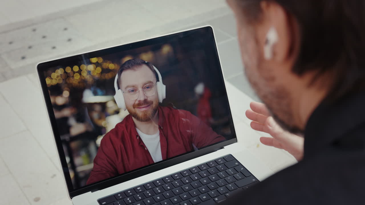 Man Talking to Colleague on Video Call via Laptop