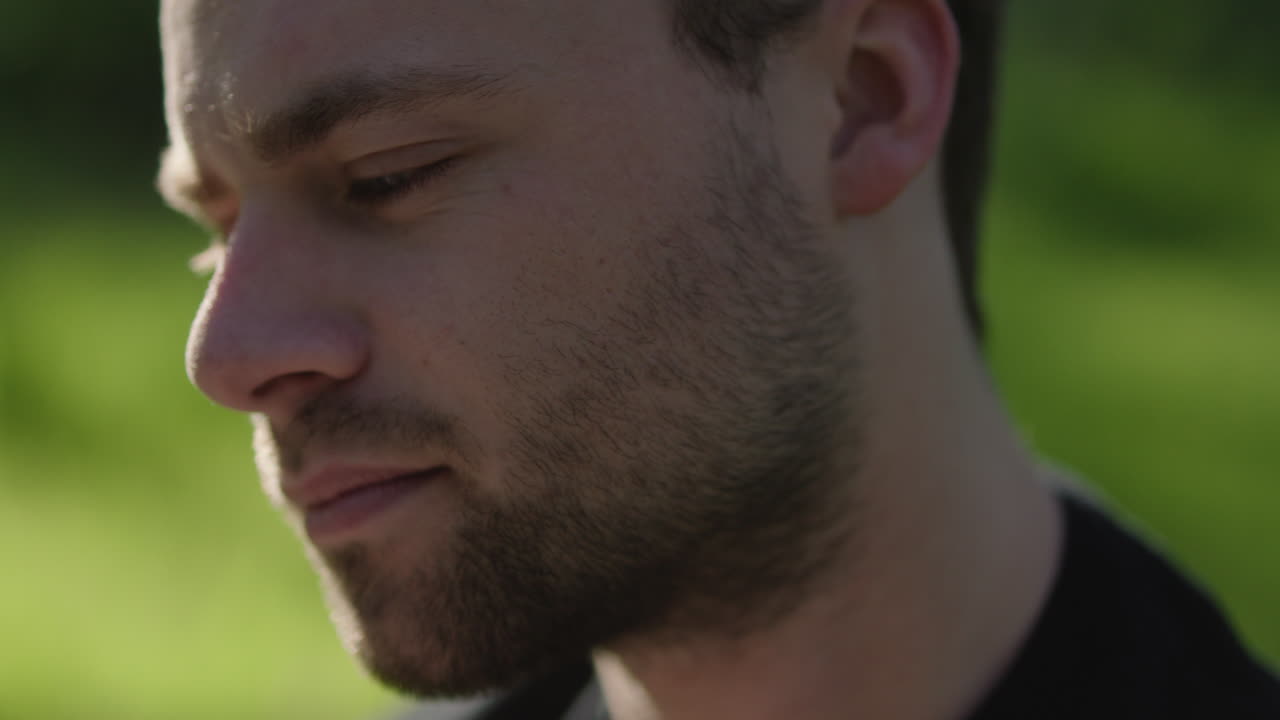 Man with beard in front of green background