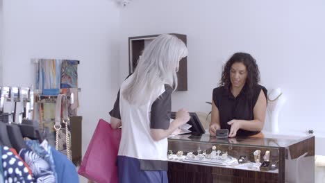 friendly latin shop cashier operating payment process