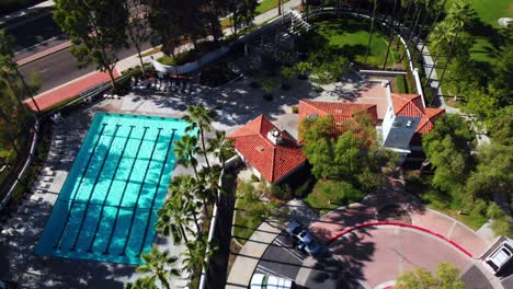 aerial drone rotation shot from community pool to park baseball field