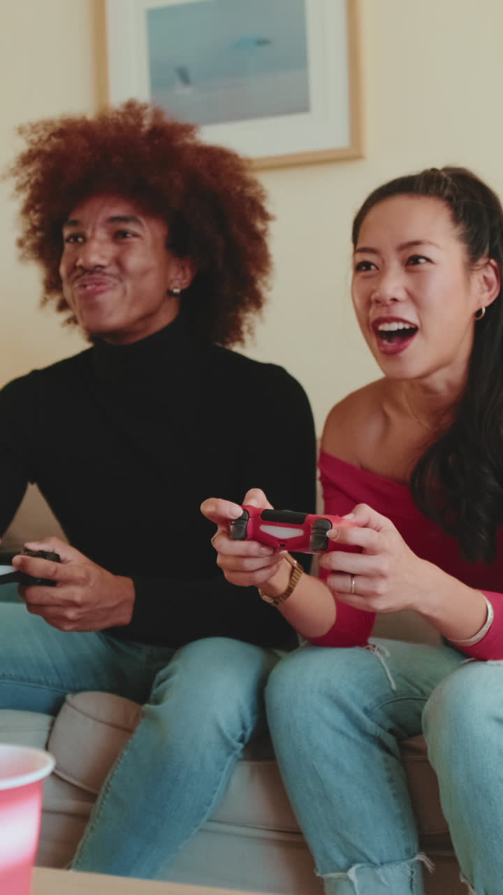 Couple playing video games on couch