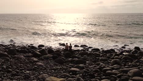 Idyllic-scene-of-two-people-at-unspoiled-virgin-beach-in-Gran-Canaria,-Spain-during-summer-time-on-vacations