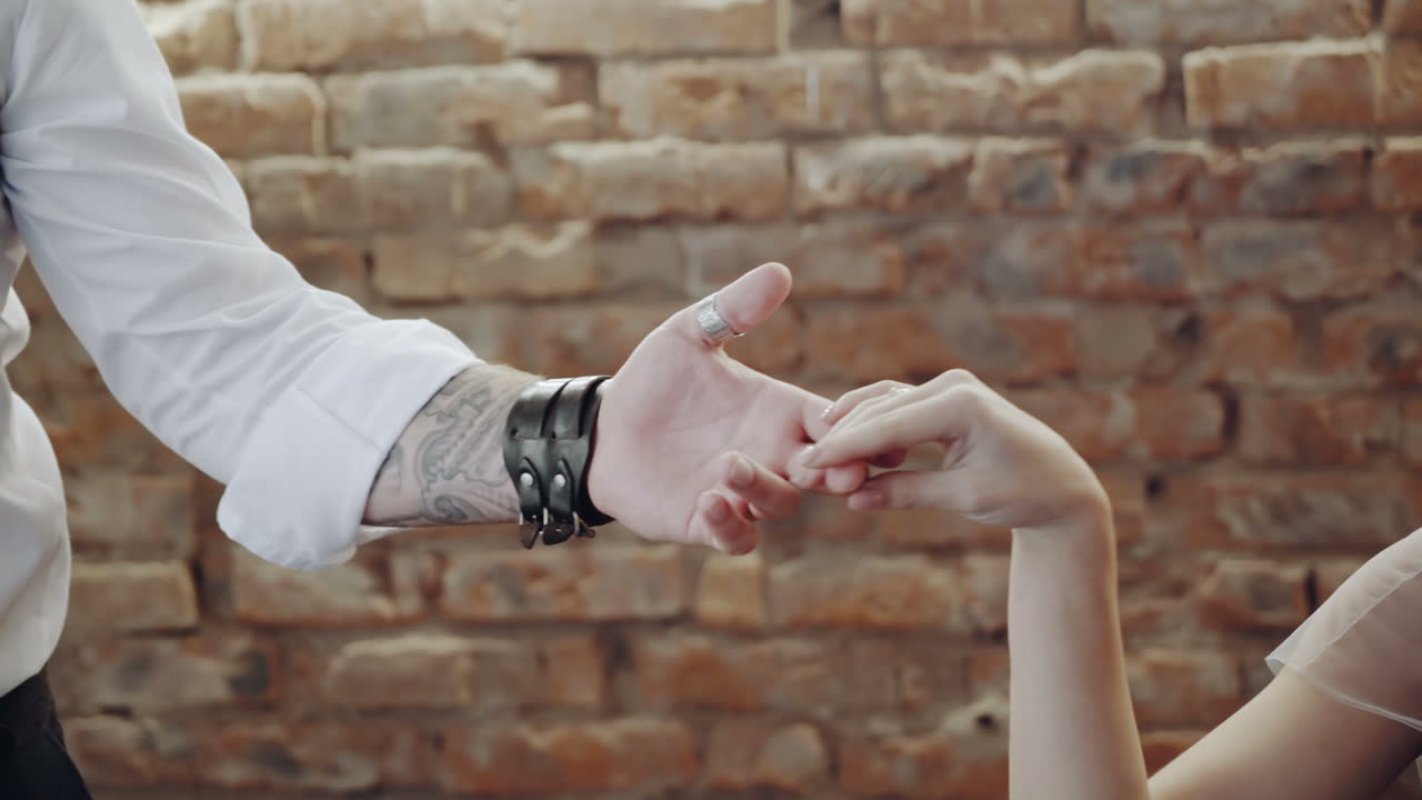 Couple touching hands. Close up of man touching the hand of his partner during a date