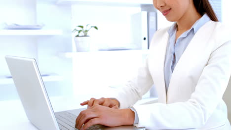 businesswoman typing on her laptop