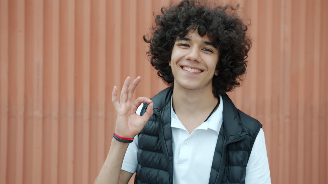 Happy Teenager Giving an Ok Gesture