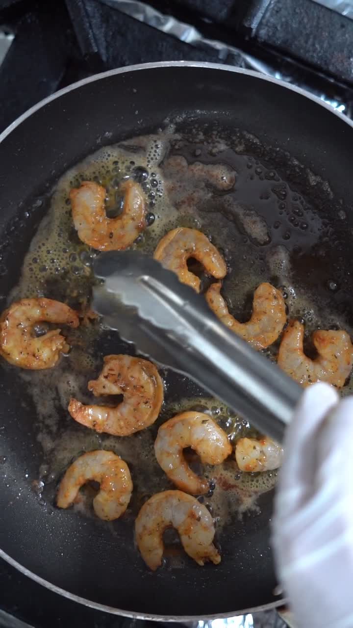 Chief fries the shrimp on a grill, close up shot, insert shot
