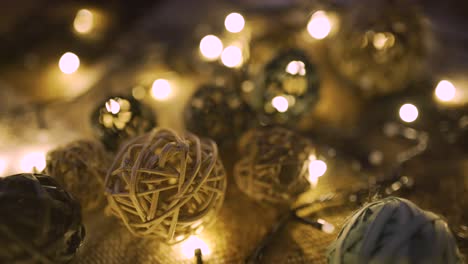 close-up christmas garland and handmade balls on a playd with golden lights. christmas concept. home decor