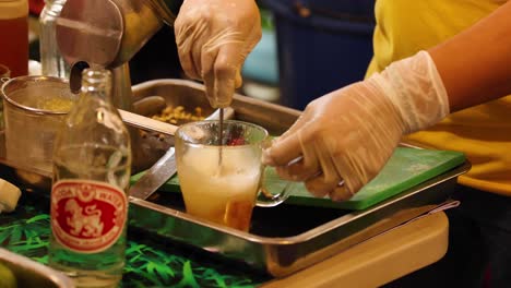 person making honey lemon soda on a tray