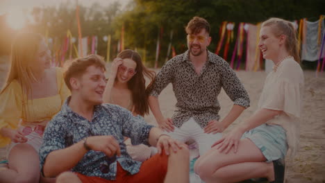 young men and women laughing at beach