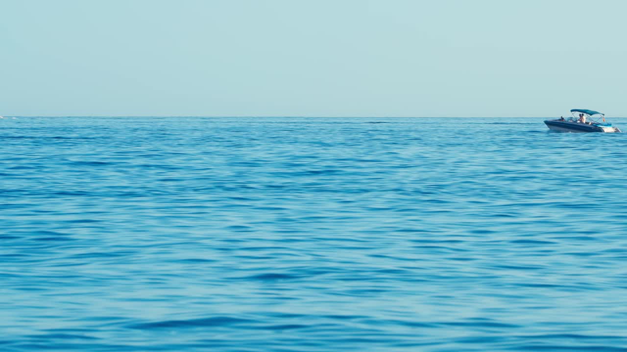 Small motorboat in the blue Mediterranean Sea