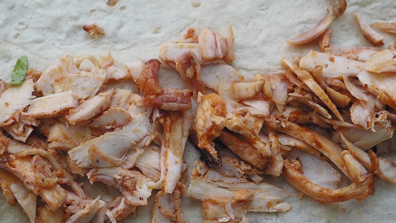 Sliced Chicken Meat on Flatbread for Shawarma Preparation