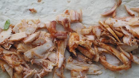 Sliced Chicken Meat on Flatbread for Shawarma Preparation