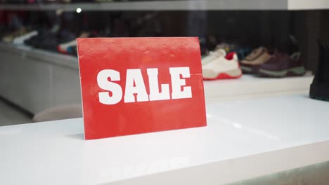 red sale sign in shoe store