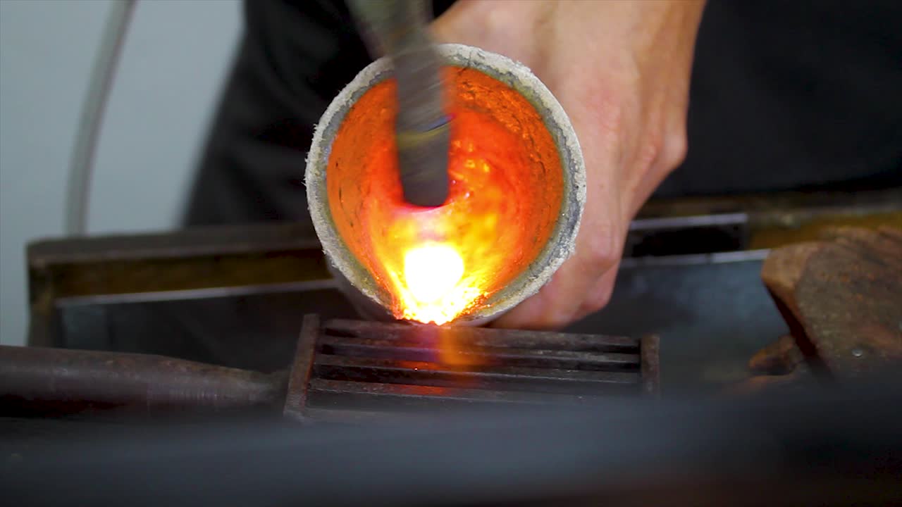 Melting metal, craft jewelry manufacturing, professional handmade fluid metal transforming process