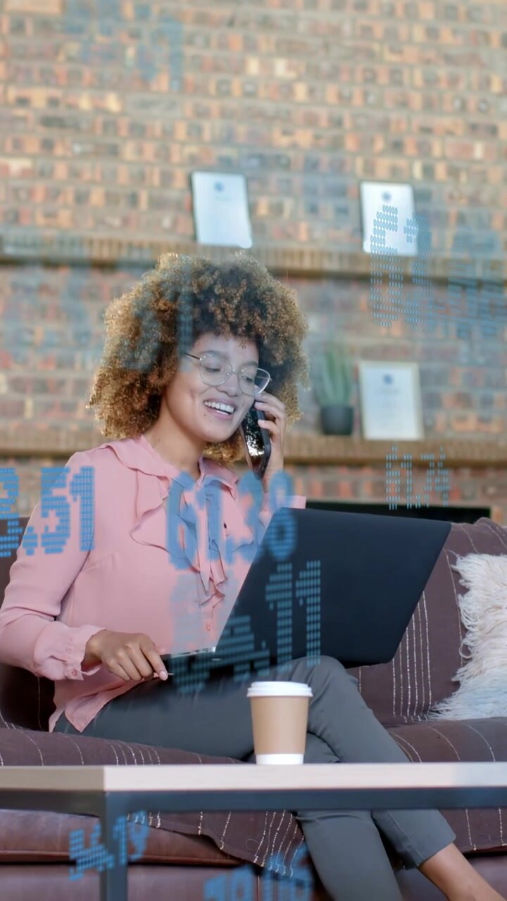Vertical video: Woman taking call, typing on laptop for business, blue numbers shifting over scene