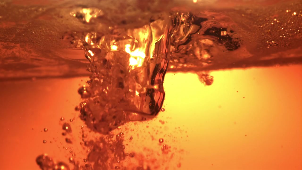 Golden Liquid Pouring and Bubbling in Slow Motion