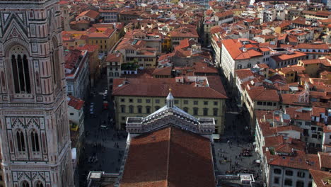 tilting timelapse of tourists milling around cathedral of santa maria del firore and giotto’s bellotower in florence