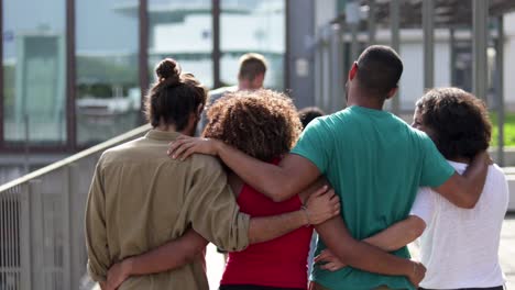 Young-friends-embracing-and-walking-outdoor