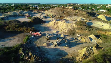 drone rise and tilt down above fill piles for construction projects, town outskirts