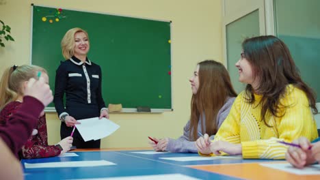 experienced teacher with students. teen schoolgirl talking to the teacher in the classroom. educational process at school. back to school.