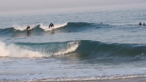 surfer on hydrofoil surfboard riding blue ocean wave