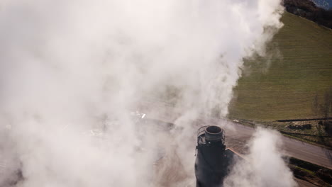 Closeup-of-factory-chimney-emitting-harmful-greenhouse-gases,-aerial