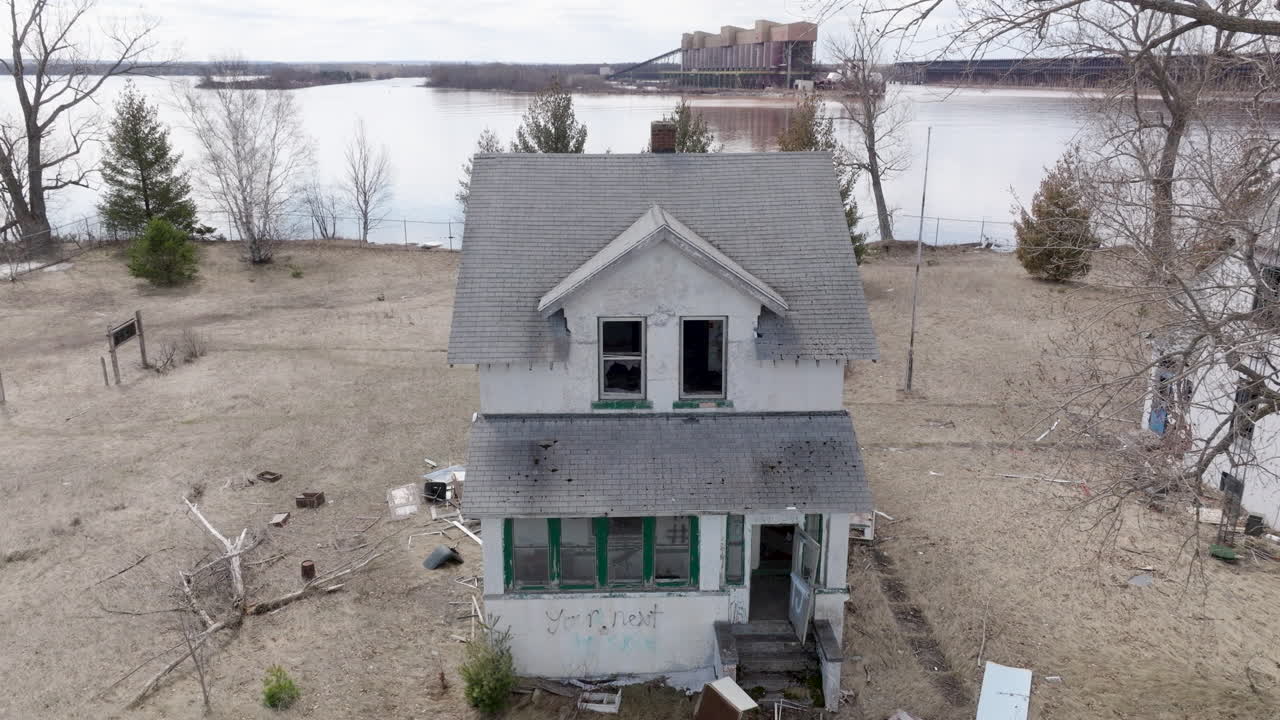 Old, decrepit houses sit empty on vacant waterfront property on Wisconsin Point along Lake Superior