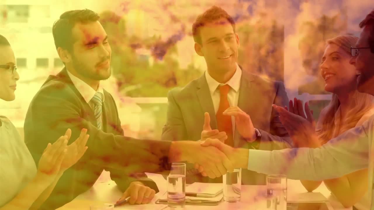 Animation of businessmen shaking hands in an office with orange clouds.