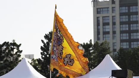 golden yellow flag waving at lunar new year celebration in taipei, taiwan