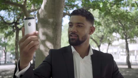 handsome bearded african american businessman with phone