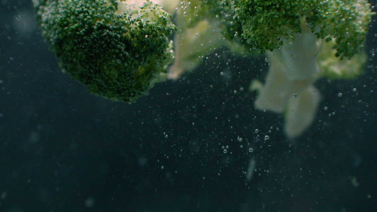Green fresh broccoli Underwater with air bubbles and in slow motion. Fresh and juicy healthy vegetarian