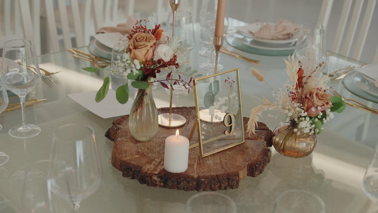 wedding reception table decorated with rustic centerpiece flowers candle and table number